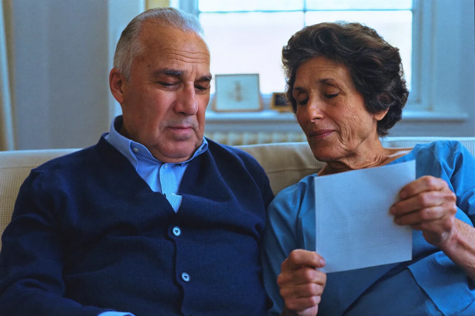 A couple reading a letter about their pension claim